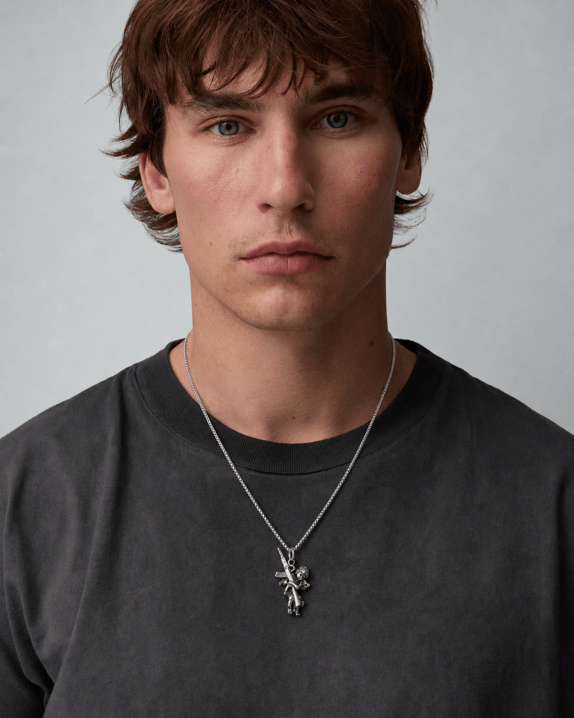 Rynor Angel Rifle Necklace – silver angel with rifle pendant necklace, worn by a model