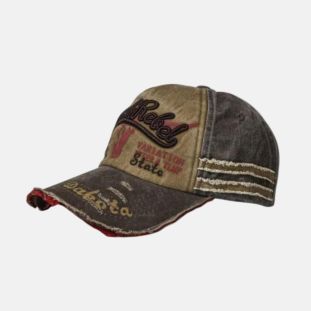 Rynor Black Rebel Cap – distressed camo and brown trucker hat with Black Rebel embroidery, worn by a model