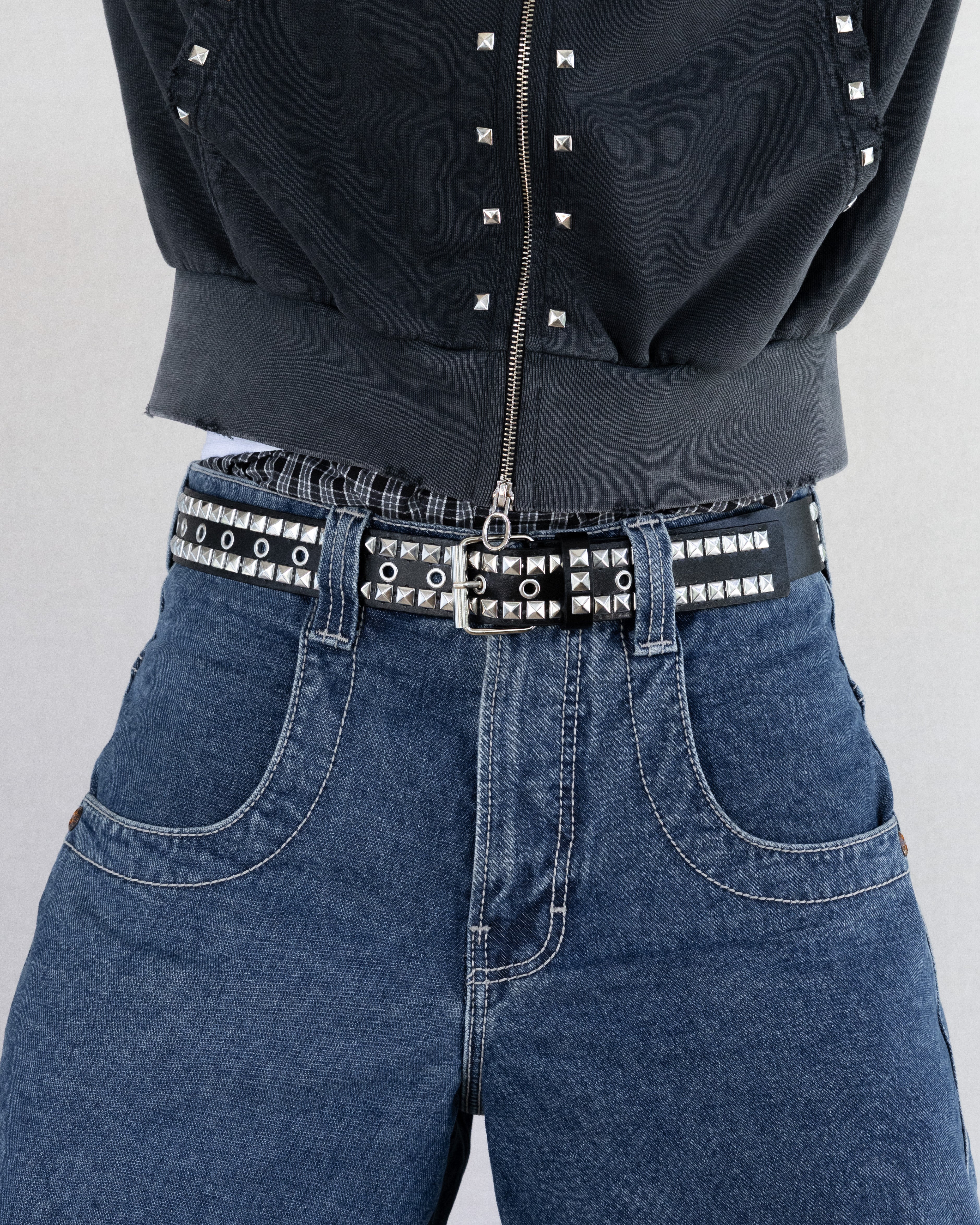 Rynor Double Studded Leather Belt – black faux leather belt with double-row pyramid studs, worn by a model