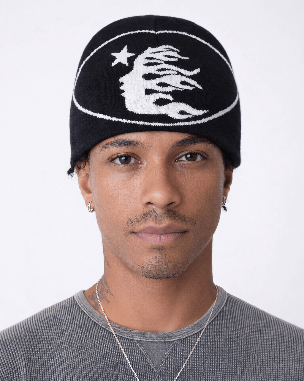 Rynor Flaming Faces Star Beanie – black knit beanie with flame face and star graphic, worn by a model