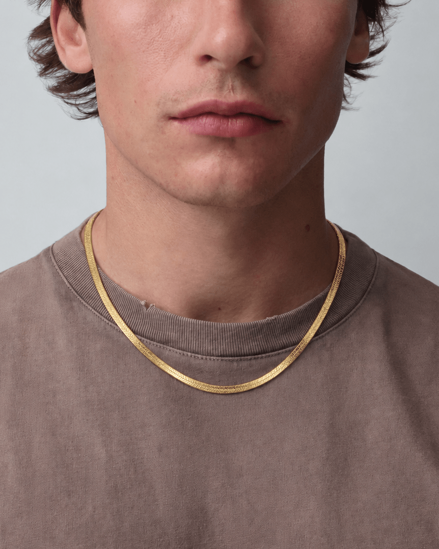 Rynor Gold Herringbone Necklace – gold-tone flat herringbone chain necklace, worn by a model