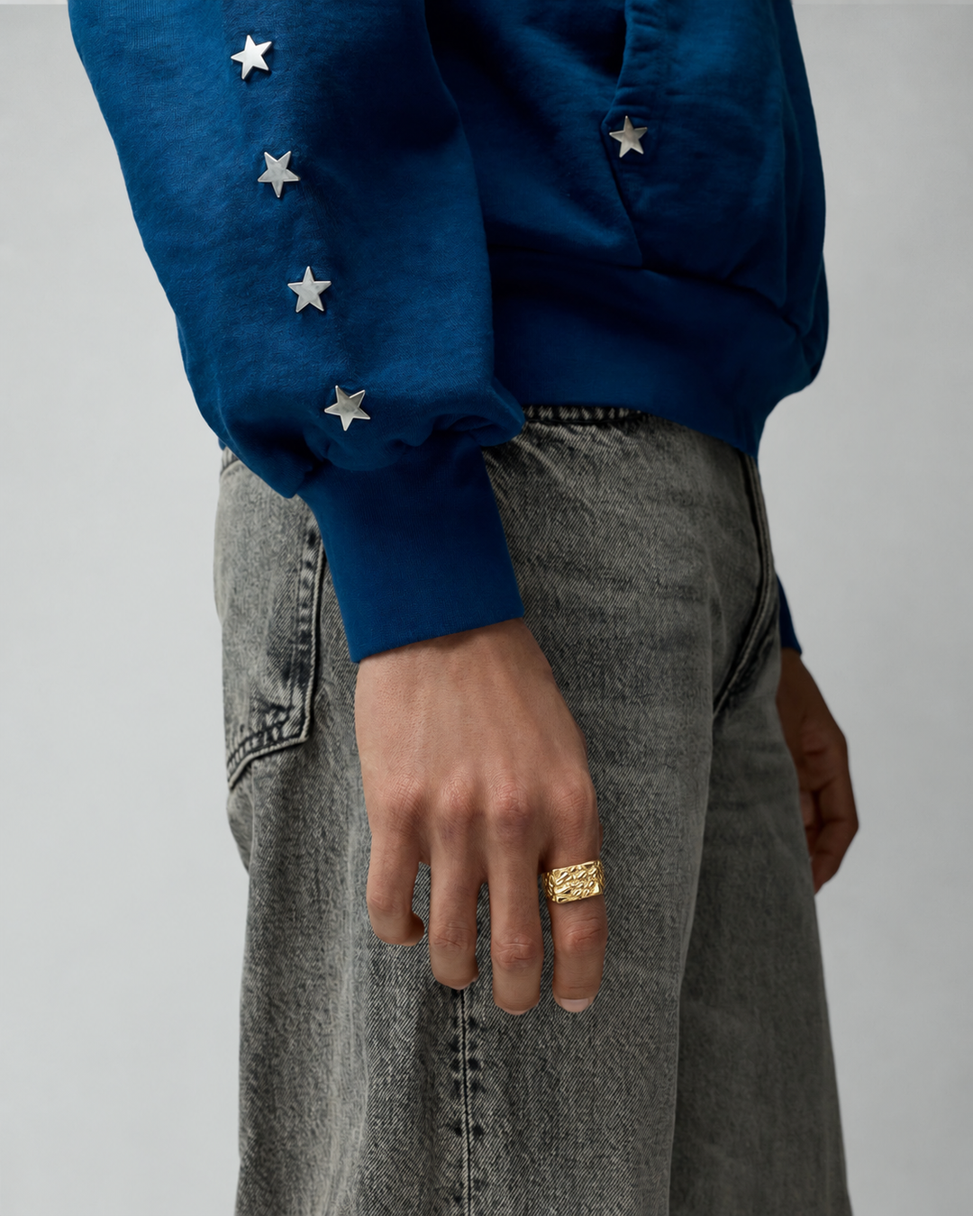 Rynor Molten Texture Ring – gold-tone ring with melted texture, worn by a model