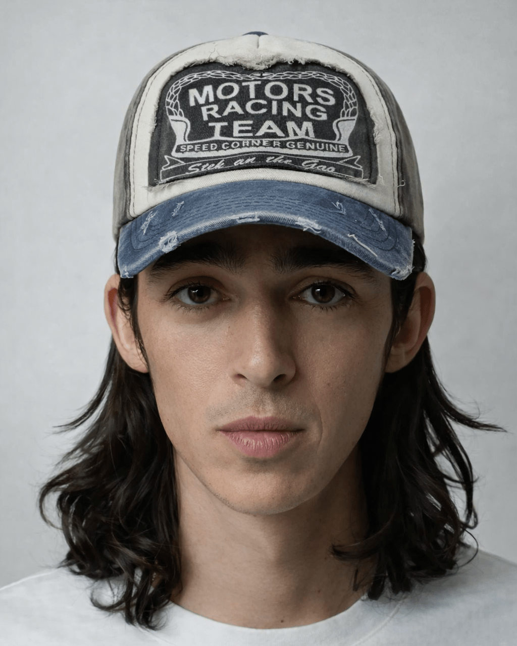 Rynor Motors Racing Team Cap – distressed blue and brown trucker hat with racing graphic, worn by a model