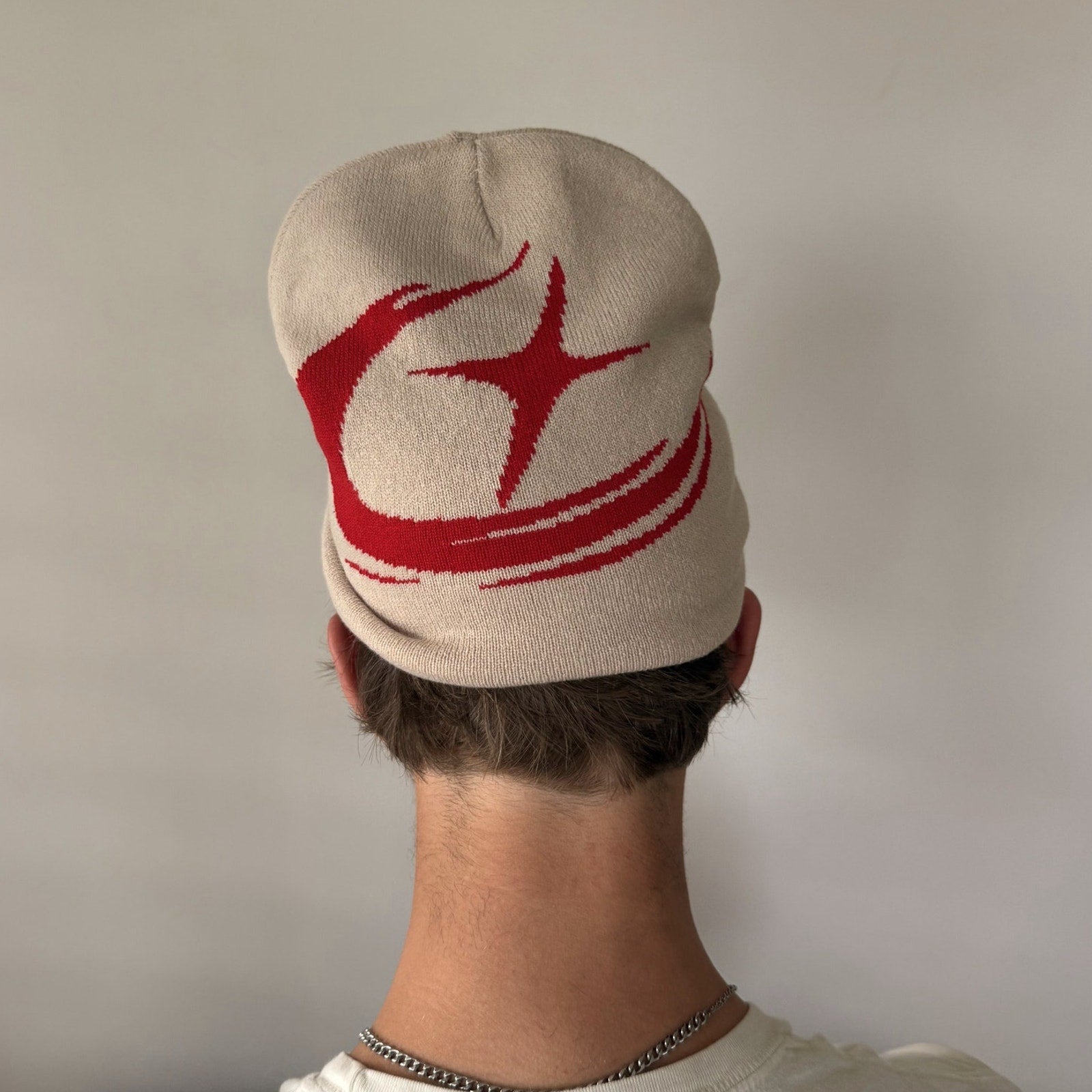 Rynor Shooting Star Beanie – beige and burgundy knit beanie with star swirl graphic, additional view