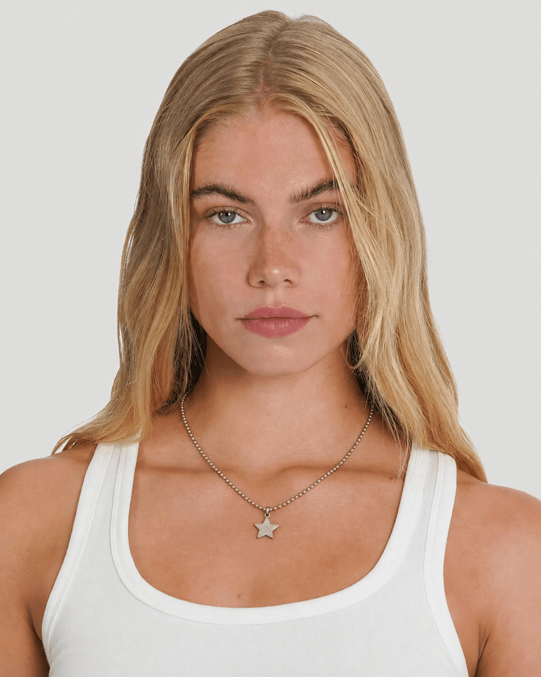 Rynor Star Icon Ball Chain – silver ball chain necklace with star charm, worn by a model