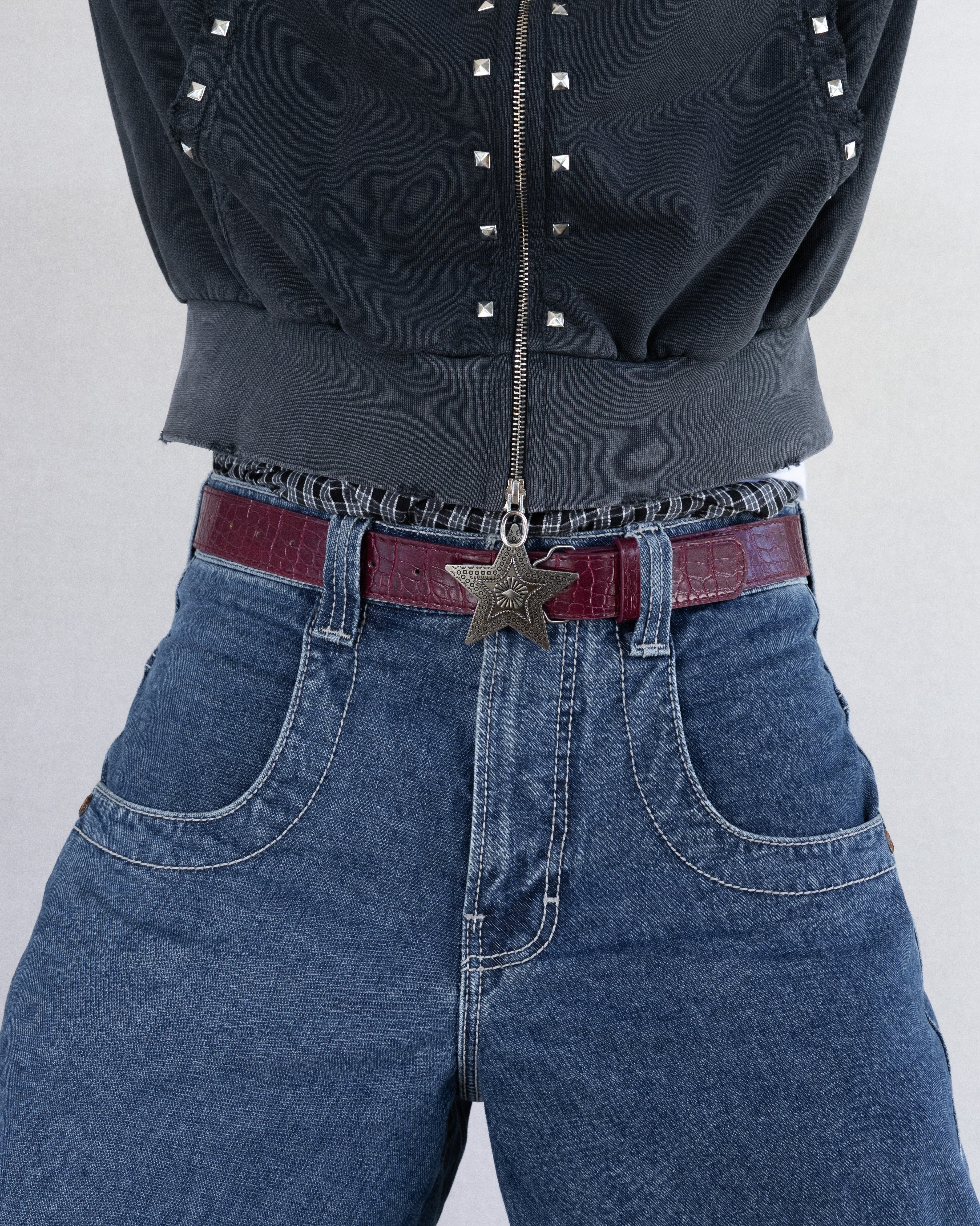 Rynor Star Medallion Belt – burgundy belt with engraved star medallion buckle, worn by a model