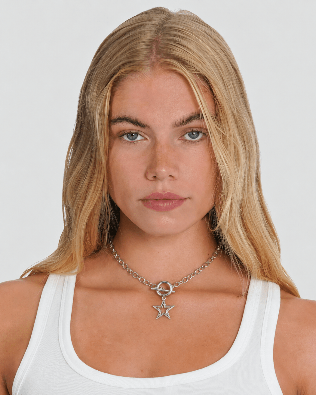 Rynor Star Toggle Necklace – silver toggle clasp chain necklace with star charm, worn by a model