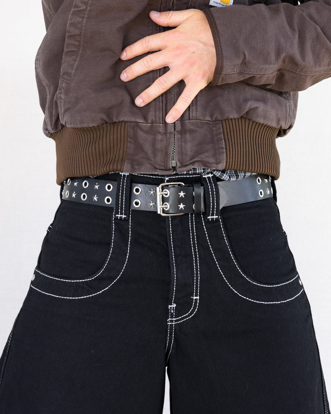 Rynor Starlight Grommet Belt – black belt with star studs and grommets, worn by a model