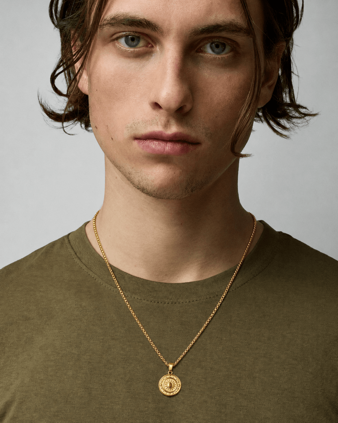 Rynor Sun Medallion Necklace – gold-tone sunburst medallion pendant necklace, worn by a model