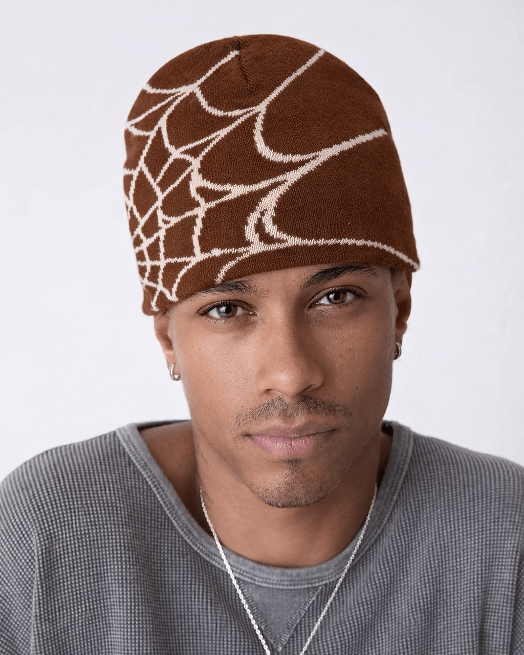 Rynor Web Knit Beanie – brown and beige spider web pattern knit beanie, worn by a model
