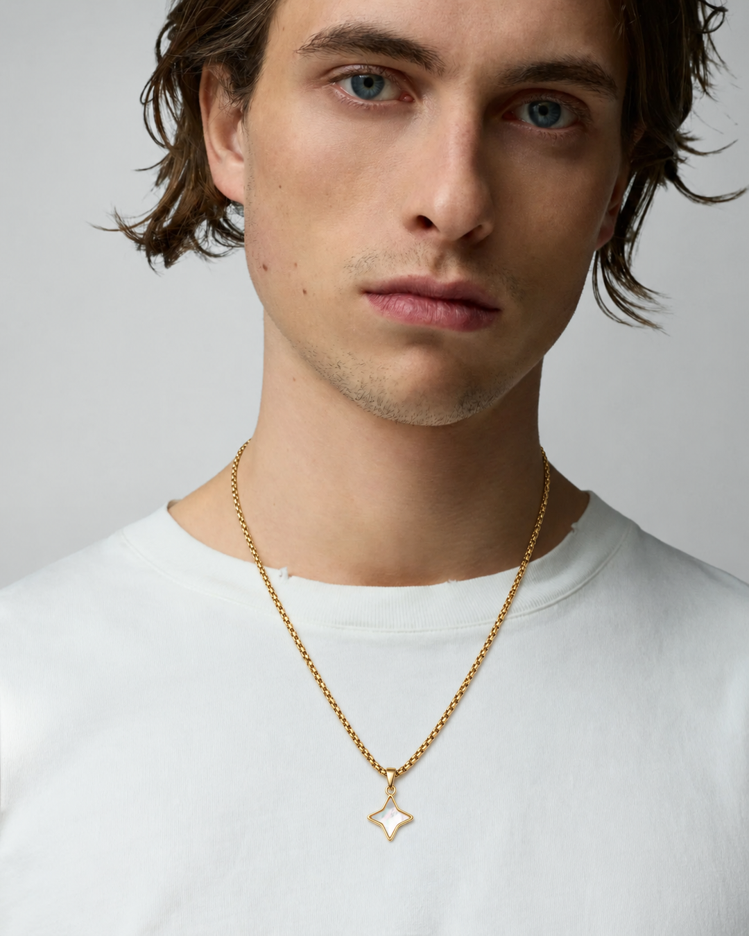Rynor White Opal Star Necklace – gold-tone chain necklace with white star-shaped stone pendant, worn by a model
