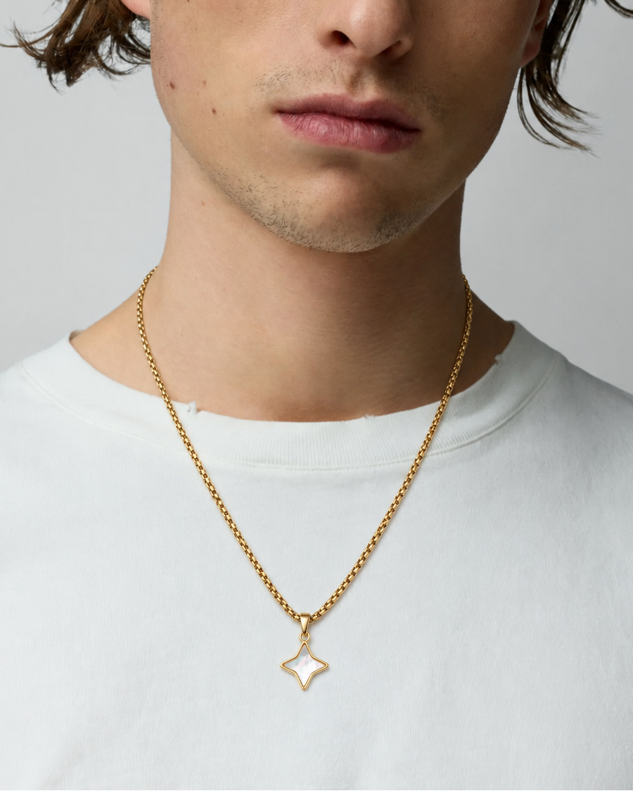 Rynor White Opal Star Necklace – gold-tone chain necklace with white star-shaped stone pendant, worn by a model