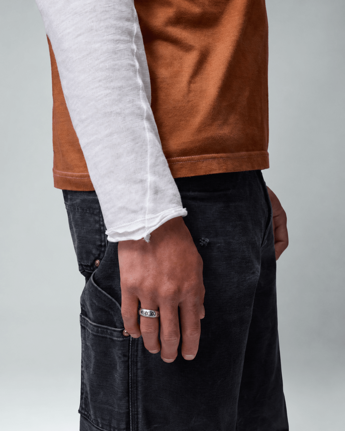 Rynor Wrapped Star Ring – 925 sterling silver ring with a star wrapping the band, worn by a model